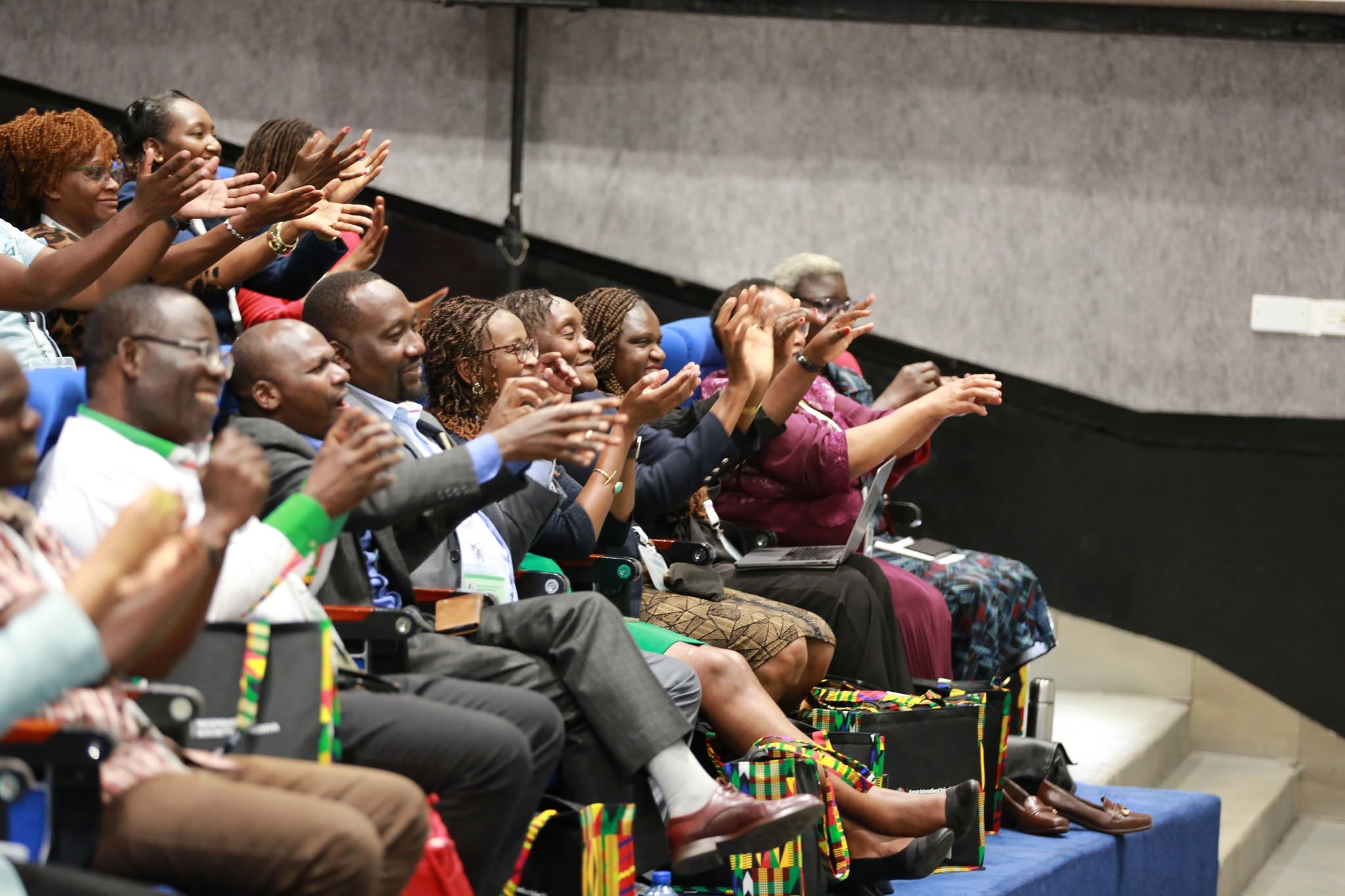 The audience applauding during the symposium
