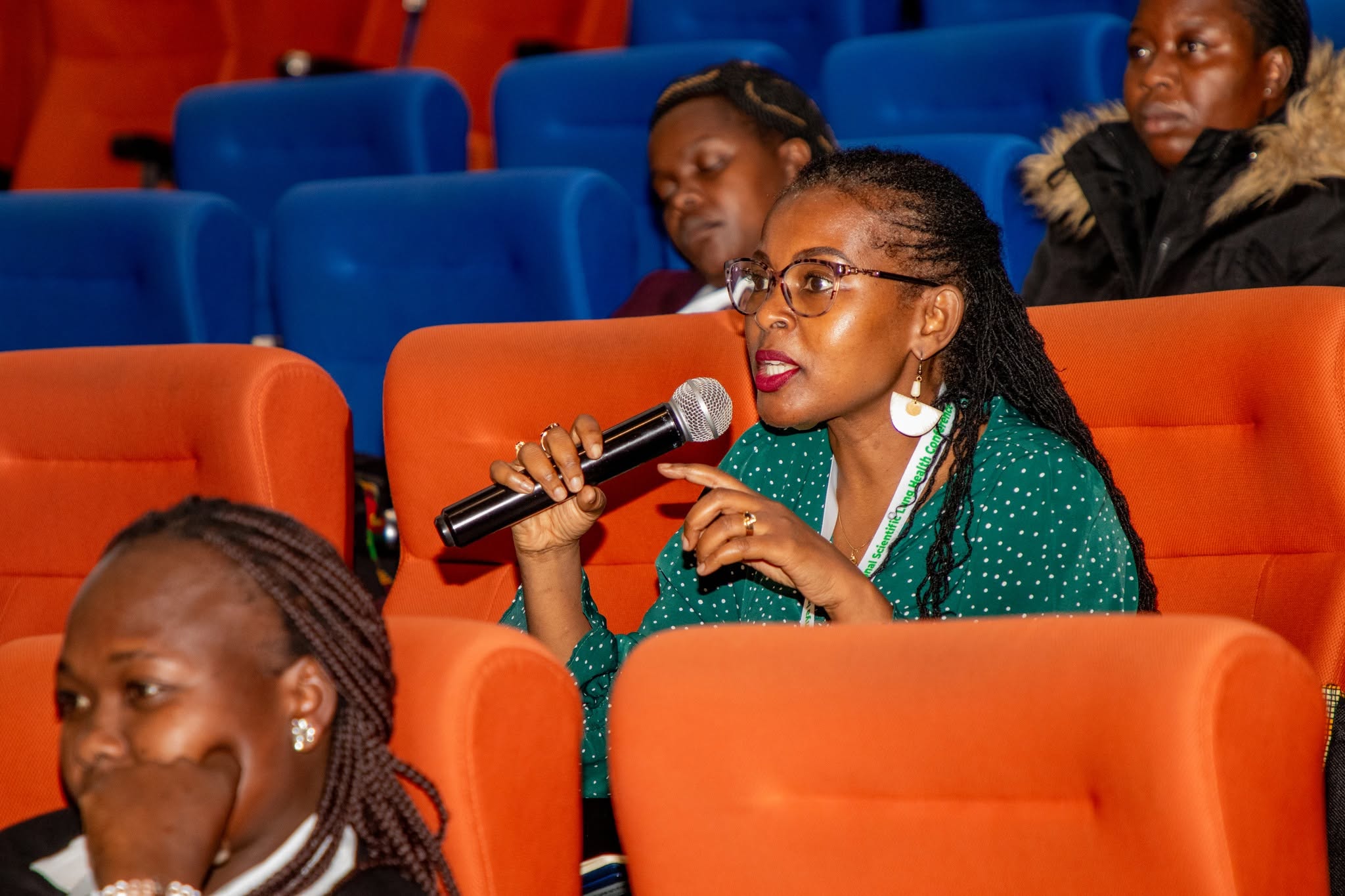 A delegate asks a question using a microphone