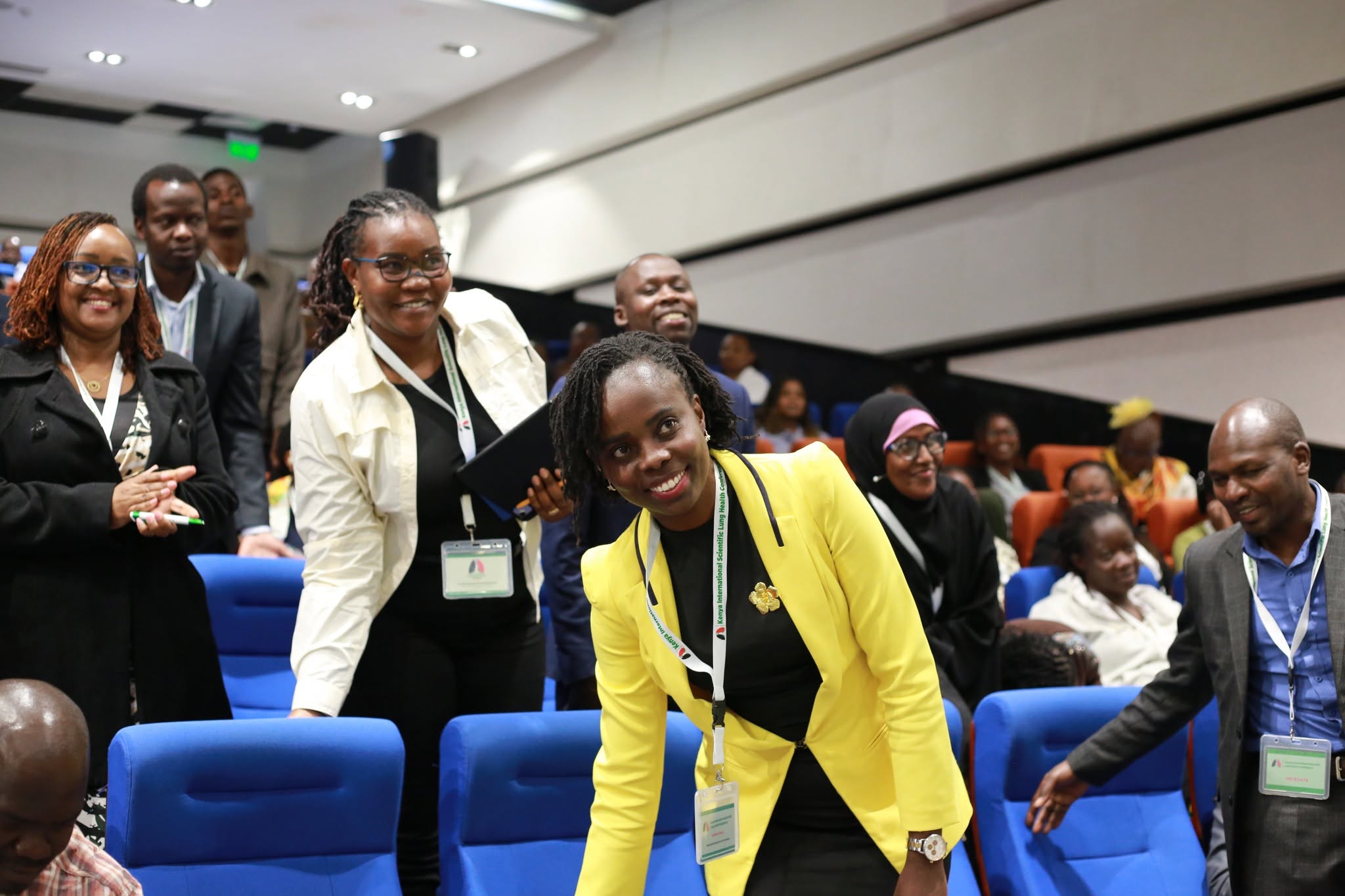 Delegates arriving and taking their seats in the auditorium