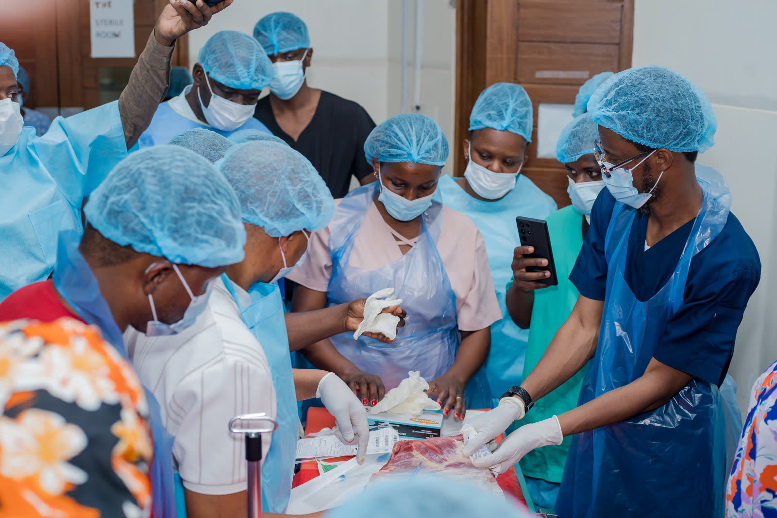 A trainer guides a group of participants through a practical station
