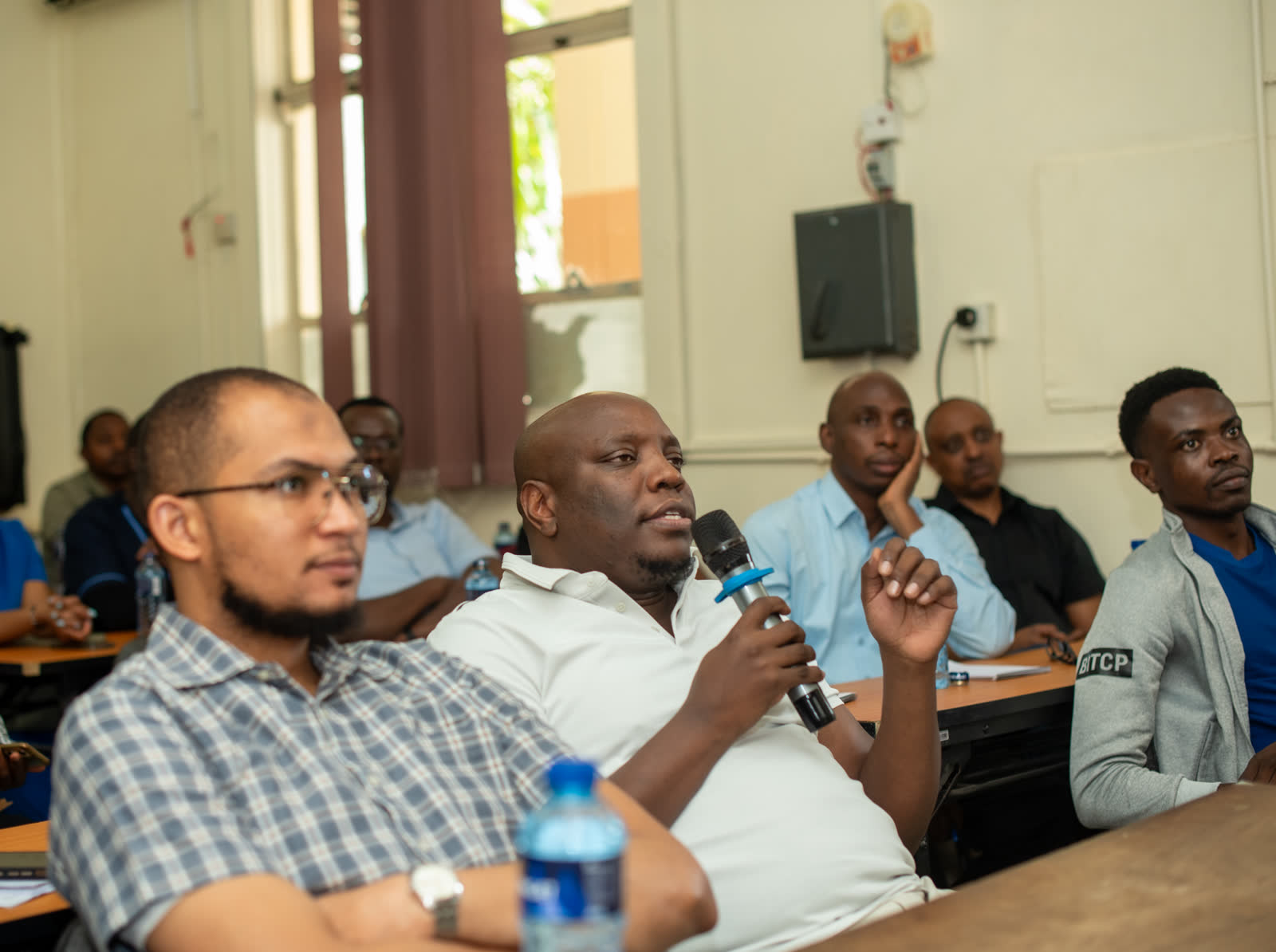 A participant contributes to the discussion from the floor